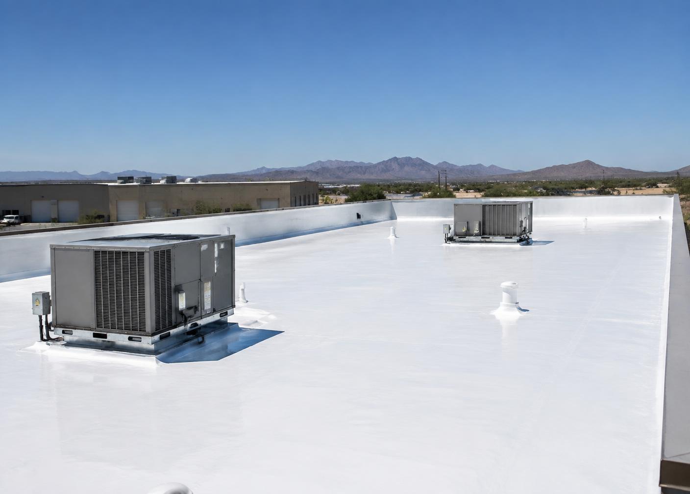 Small warehouse low-slope roof finished with a white reflective coating