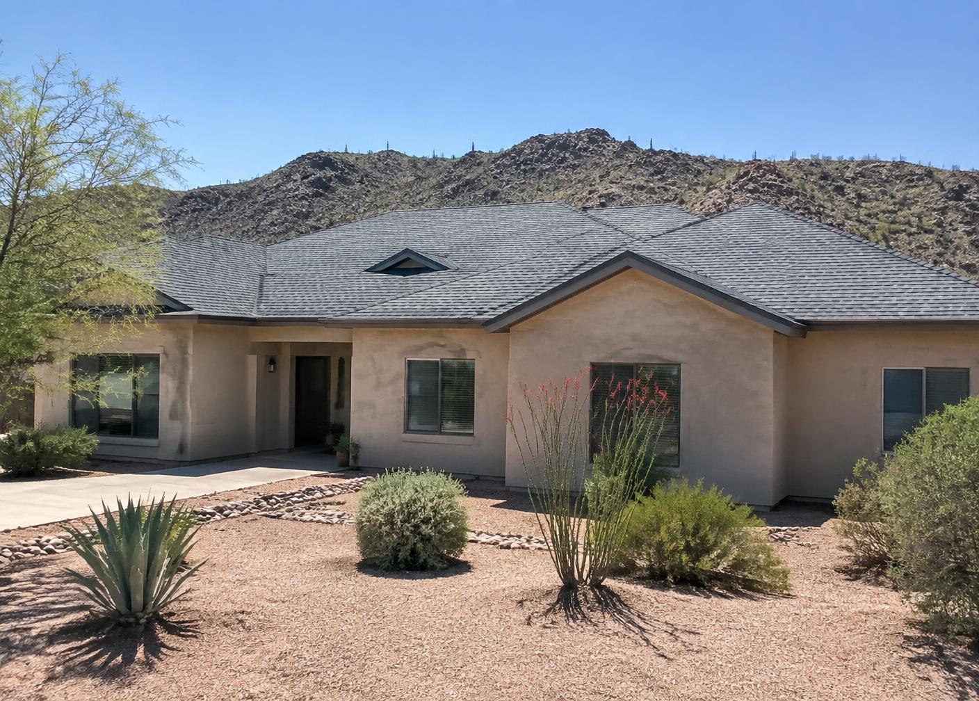 Southwestern stucco home with a newly installed architectural shingle roof